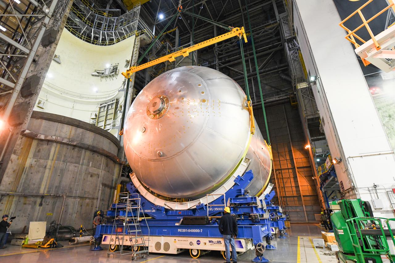This image shows the latest progress NASA has made in manufacturing the liquid oxygen tank for the second core stage of NASA’s Space Launch System (SLS) rocket. The liquid oxygen tank will be used for the first crewed mission, Artemis II, of the agency’s Artemis program. Teams at NASA’s Michoud Assembly Facility in New Orleans recently completed internal cleaning of the liquid oxygen, or LOX, tank at the facility. Following the cleaning, crews prepared the propellant tank for the next phase of phase of assembly in a different area of the factory by moving, or breaking over, the tank from a vertical to horizontal position. The LOX tank is one of five major elements that make up the rocket’s massive 212-foot-tall core stage. The propellant tank holds 196,000 gallons of supercooled liquid oxygen to help fuel four RS-25 engines, and the internal cleaning ensures no contaminants make their way into the complex propulsion and engine systems of the deep space rocket. The stage, which includes a cluster of four RS-25, will produce more than 2 million pounds of thrust to help launch the SLS rocket and astronauts aboard NASA’s Orion spacecraft around the Moon for Artemis II.   NASA is working to land the first woman and the next man on the Moon by 2024. The agency’s SLS rocket offers more payload mass, volume capability and energy to speed missions through deep space and enable NASA’s Artemis lunar program. SLS, along with Orion, the human landing system, and the Gateway in orbit around the Moon are NASA’s backbone for deep space exploration. No other rocket is capable of carrying astronauts in Orion around the Moon in a single mission.